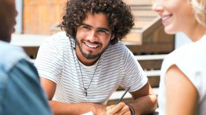 Smiling multiethnic guy with his friends