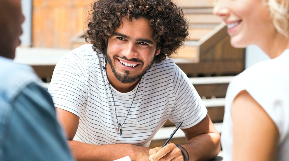 Smiling multiethnic guy with his friends