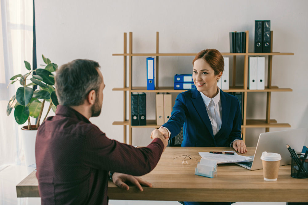 Smiling businesswoman and client shaking hands on meeting in office | Tips For Overcoming Sales Objections With Ease | overcome sales objections